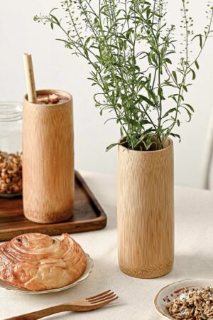 A smooth bamboo cup which is perfect for drinks or as a decorative vase