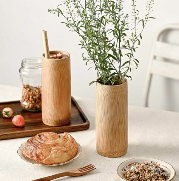 A smooth bamboo cup which is perfect for drinks or as a decorative vase
